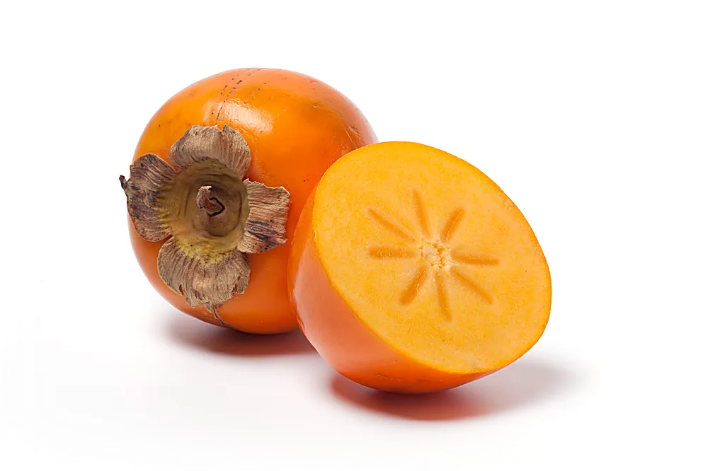 Persimmon cut in half showing the flesh